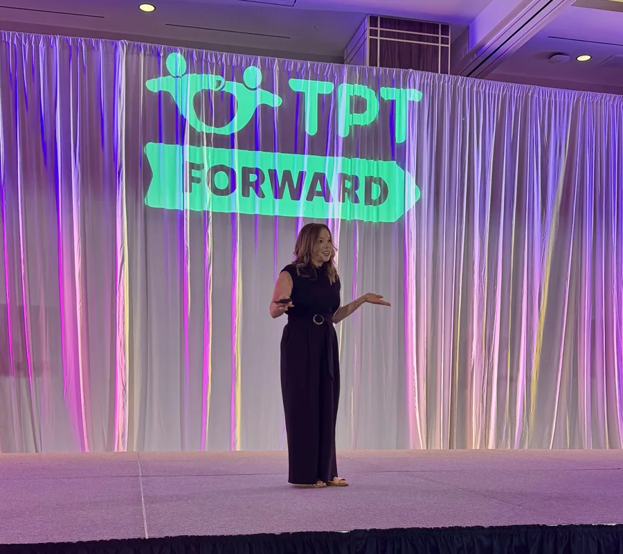Erin on stage in front of the TPT Forward sign